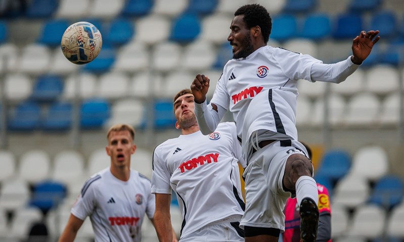 Club players challenging for a high ball during a match